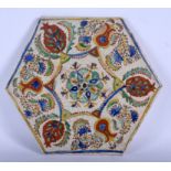 AN EARLY 18TH CENTURY KUTAHYA POTTERY HEXAGONAL FAIENCE TILE painted with floral sprays. 21 cm wide
