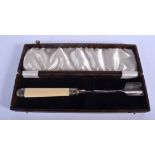 A CASED ANTIQUE SILVER MOUNTED IVORY STILTON SCOOP. 24 cm long.