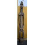 A LARGE CENTRAL AFRICAN PUNU CARVED WOODEN STATUE, formed as an elongated female. 126 cm high.