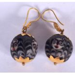 AN UNUSUAL PAIR OF HIGH CARAT GOLD MOUNTED GLASS EARRINGS, decorated with abstract faces. 4.25 cm l