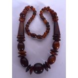 AN EARLY 20TH CENTURY RHINOCEROS HORN NECKLACE, formed with varied beads. 50 cm long.