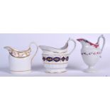 A MILES MASON HARD PASTE HYBRID CREAM JUG, together with a A & E Keeling jug and another. Largest 1