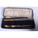 AN EARLY 20TH CENTURY HORN HANDLED CARVING SET, together with case. Case 35 cm wide.