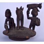 A WEST AFRICAN WOODEN HEADDRESS, formed with a young boy beside a goat. 31 cm x 31 cm.