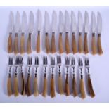 A GOOD SET OF TWENTY SIX 19TH CENTURY CARVED RHINOCEROS HORN KNIVES AND FORKS with English silver m