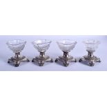 FOUR ANTIQUE SILVER AND GLASS SALTS. (4)