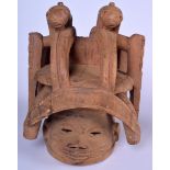 A WEST AFRICAN WOODEN MASK HEADDRESS, carved with two elongated pigs. 42 cm x 32 cm.