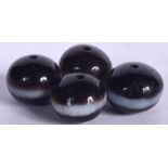 FOUR CENTRAL ASIAN AGATE BEADS, flattened spherical in form. 1.75 cm wide. (4)