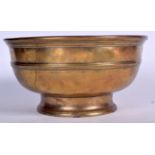 A LARGE 19TH CENTURY BRASS PEDESTAL BOWL, formed with a ribbed body. 26.5 cm wide.