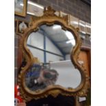 AN ANTIQUE GILTWOOD MIRROR, formed with scrolling foliate inspired border. 53 cm x 37 cm.