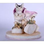 AN EARLY 20TH CENTURY BISQUE CAT FIGURAL DOUBLE SPILL VASE, formed emerging from a pair of boots, i