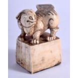AN 18TH CENTURY JAPANESE EDO PERIOD CARVED IVORY SEAL formed with a seated beast. 4.75 cm x 3.25 cm