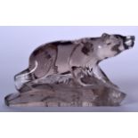 A 20TH CENTURY CARVED ROCK CRYSTAL FIGURE OF A BEAR, formed upon a naturalistic base. 9 cm x 15 cm.