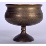 AN EARLY 20TH CENTURY ISLAMIC BRASS PEDESTAL BOWL, engraved with extensive foliage. 16.5 cm x 17 cm