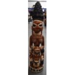 A LARGE NIGERIAN YORUBA POLYCHROMED WOODEN STATUE, formed as a standing figure with three attendant