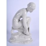 A RARE ROYAL DOULTON LAMBETH FIGURE OF A NYMPH by Gilbert Bayes (1872-1954). 22 cm high.