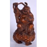A CHINESE BAMBOO FIGURE OF BUDDHA, modelled seated upon a spotted toad. 15 cm high.