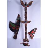 A CANADIAN NORTHER AMERICAN HAIDA TRIBAL CARVED FLYING EAGLE together with two others and a totem,