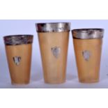 A SET OF THREE SCOTTISH SILVER MOUNTED HORN BEAKERS, set with silver shield shaped cartouche. Large