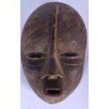 A CONGOLESE WOODEN WOYO MASK, carved with shark like teeth. 23 cm x 16 cm.