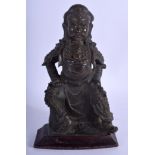 A 17TH CENTURY CHINESE BRONZE FIGURE OF A SEATED GUARDIAN Ming, modelled in armour. Bronze 22 cm x