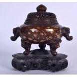 A CHINESE GOLD SPLASH BRONZE CENSER, formed with elephant mask head handles, together with a wooden