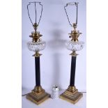 A LARGE PAIR OF EDWARDIAN BRONZE AND CRYSTAL GLASS LAMPS upon stepped bases. 62 cm high not inc fit