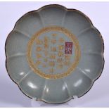 A CHINESE CELADON CRACKLE GLAZED LOBED DISH, decorated with gilt calligraphy. 18.5 cm wide.