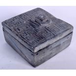 AN INDIAN STONE BOX AND COVER, the lid carved in relief with a serpent. 7 cm x 13.5 cm.