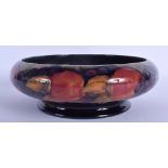 A 1930S MOORCROFT POTTERY BOWL decorated with grapes and peaches. 23 diameter.