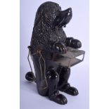 AN ANTIQUE BAVARIAN BLACK FOREST SMOKERS COMPANION SEATED HOUND. 28 cm x 13 cm.