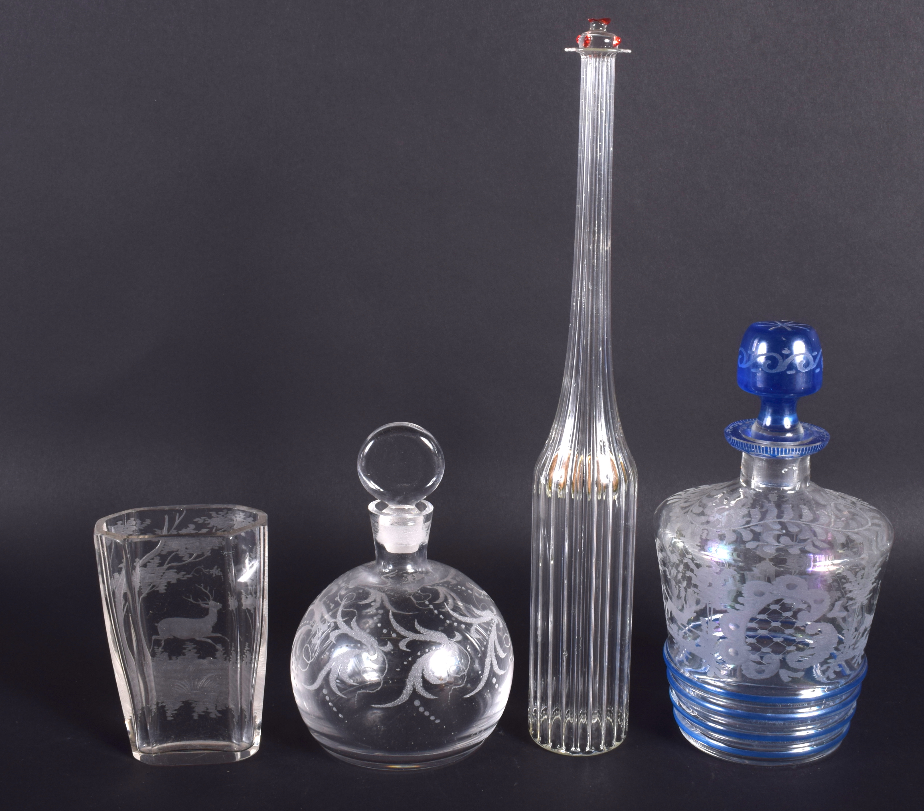 AN ANTIQUE BOHEMIAN CLEAR GLASS VASE together with three bottles. Largest 29 cm high. (4) - Image 2 of 2