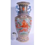 A VERY LARGE CHINESE TWIN HANDLED PORCELAIN VASE C1960 painted with dragons amongst foliage. 55 cm