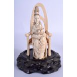 A 19TH CENTURY JAPANESE MEIJI PERIOD CARVED IVORY OKIMONO modelled as a female on a chair. 18 cm x