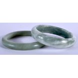 TWO CHINESE JADEITE BANGLES 20th Century. 7.5 cm wide. (2)