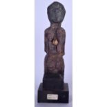 A MALIAN DOGON CARVED WOODEN FIGURE, inset with shell decoration to body. 31.5 cm high.