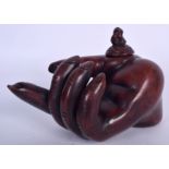 A POTTERY TEA POT IN THE FORM OF A HAND, the finial in the form of a seated figure. 17 cm wide.