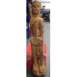 AN UNUSUAL LARGE WEST AFRICAN CARVED STATUE, formed with three metal screw articles fixed to belt.