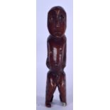 A WEST AFRICAN CARVED BONE STATUE, formed with bulging eyes and circular motifs to body. 29 cm high