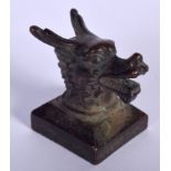 A CHINESE BRONZE SEAL, the terminal in the form of a dragon head. 4.25 cm high.