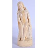 A 19TH CENTURY ANGLO INDIAN CARVED IVORY FIGURE OF A STANDING FEMALE modelled resting upon a rocky