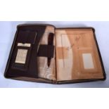 A 1930'S LEATHER WRITING PAD, including calendar, folding knife etc. 25 cm x 20 cm when closed.