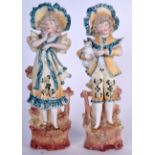 A PAIR OF BISQUE FIGURINES, in the form of standing children. 35 cm high.