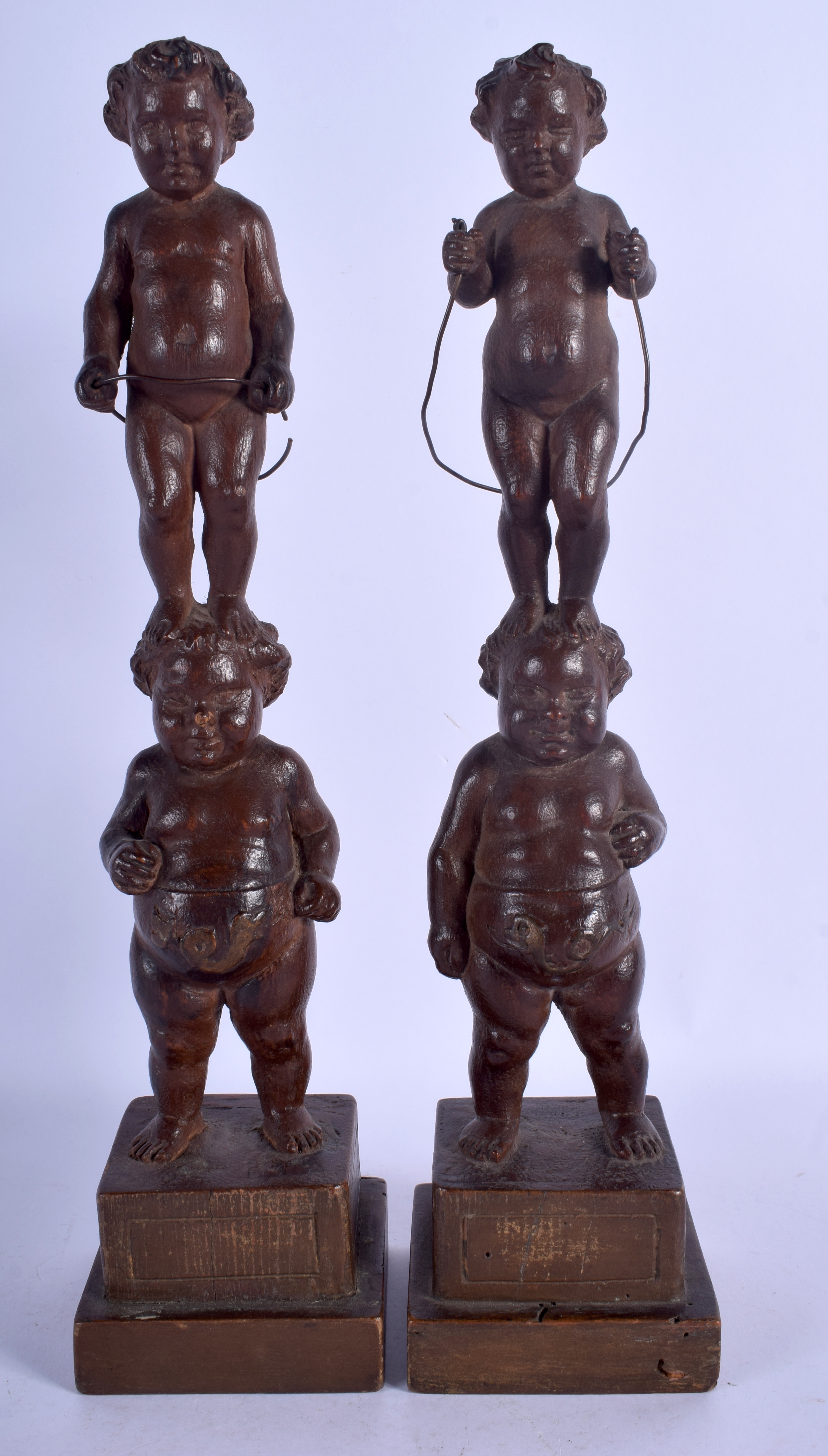 A PAIR OF 19TH CENTURY CONTINENTAL CARVED WOOD FIGURE OF PUTTI modelled upon square form bases. 35. - Image 2 of 3