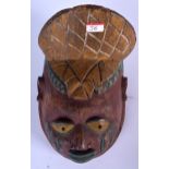 A NIGERIAN YORUBA POLYCHROMED WOODEN MASK, formed with an elongated face. 32 cm x 17 cm.