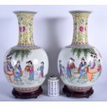 A PAIR OF CHINESE REPUBLICAN PERIOD FAMILLE ROSE VASES painted with figures within a landscape. 43