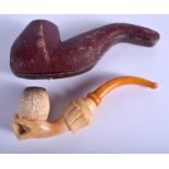 A LARGE ANTIQUE CARVED MEERSCHAUM AND AMBER FIST PIPE. 15 cm long.