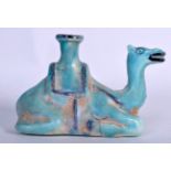 A BLUE GLAZED KASHAN POTTERY CANDLESTICK HOLDER, in the form of a seated camel. 21 cm wide.