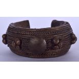AN IVORY COAST BAOULE BRONZE BANGLE, formed with rope twist decoration. 9 cm wide.
