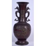 A 19TH CENTURY JAPANESE MEIJI PERIOD TWIN HANDLED BRONZE VASE decorated with foliage. 32 cm high.